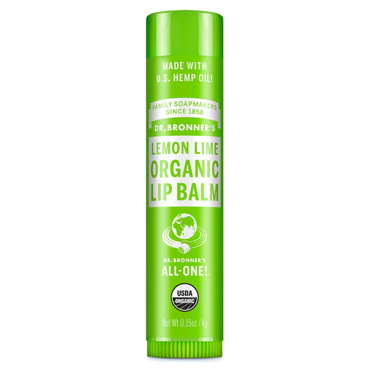 A green tube labeled Dr. Bronners Organic Lip Balm Peppermint stands upright, featuring certifications and text about organic and fair trade ingredients, set against a plain white background [.15 oz]