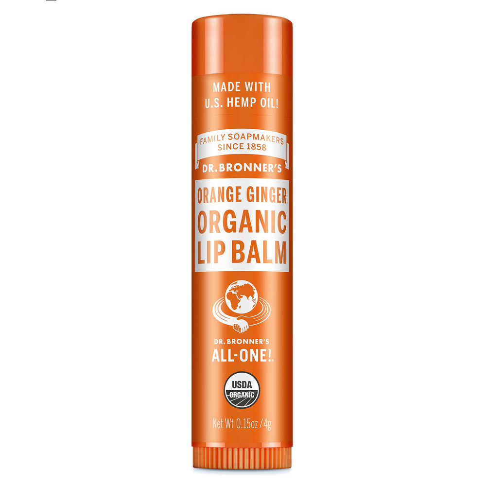 Dr. Bronners Orange Ginger Organic Lip Balm, with U.S. hemp oil, stands upright against a white background. Text includes Family Soapmakers Since 1858, All One, USDA Organic, Net Wt 0.15oz4g [.15 oz]