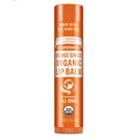 Dr. Bronners Orange Ginger Organic Lip Balm, with U.S. hemp oil, stands upright against a white background. Text includes Family Soapmakers Since 1858, All One, USDA Organic, Net Wt 0.15oz4g [.15 oz]