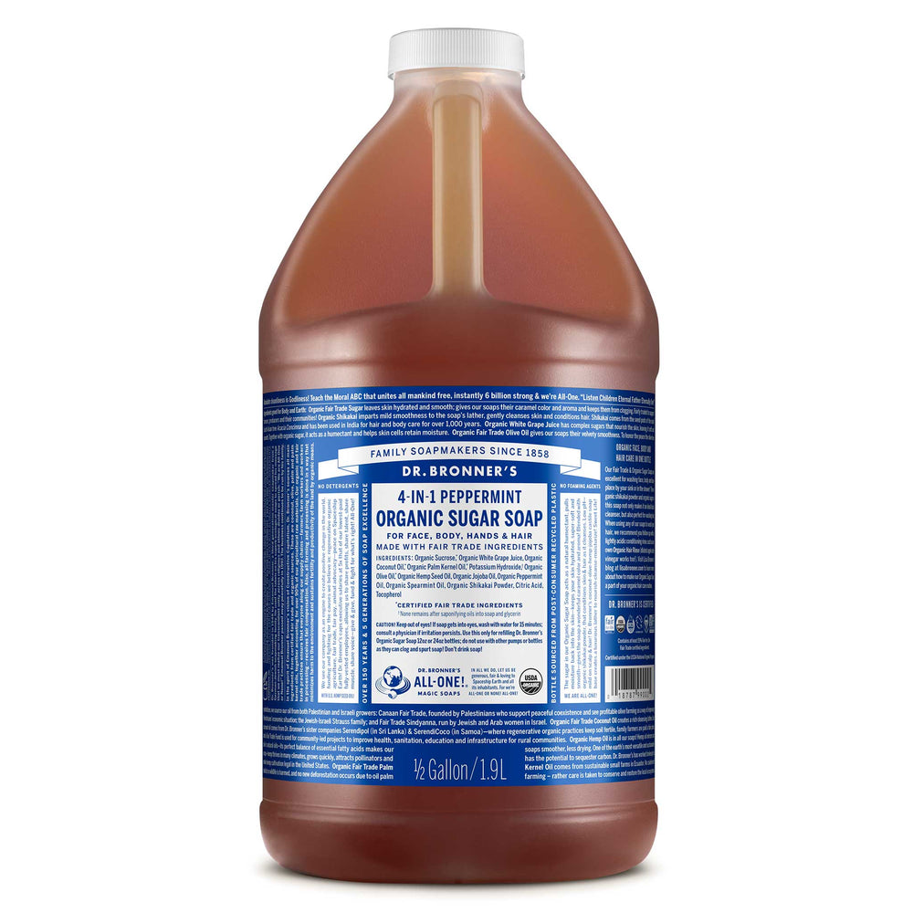 A large bottle of Dr. Bronners 4 in 1 Peppermint Organic Sugar Soap is displayed, featuring a blue label depicting detailed product information and branding for versatile uses. It emphasizes the bottles capacity of 12 gallon [1/2 Gallon]