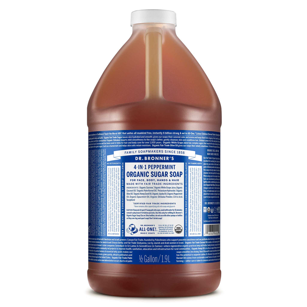 A large bottle of Dr. Bronners 4 in 1 Peppermint Organic Sugar Soap is displayed, featuring a blue label depicting detailed product information and branding for versatile uses. It emphasizes the bottles capacity of 12 gallon [1/2 Gallon]