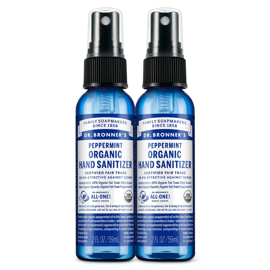 Two blue 2 fl oz bottles of Dr. Bronners Peppermint Organic Hand Sanitizer with spray tops, labeled as certified fair trade. Text reads FAMILY SOAPMAKERS SINCE 1858, PEPPERMINT ORGANIC HAND SANITIZER, CERTIFIED FAIR TRADE, and ALL ONE Ideal for eco friendly hygiene