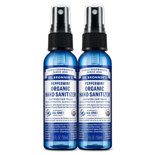 Two blue 2 fl oz bottles of Dr. Bronners Peppermint Organic Hand Sanitizer with spray tops, labeled as certified fair trade. Text reads FAMILY SOAPMAKERS SINCE 1858, PEPPERMINT ORGANIC HAND SANITIZER, CERTIFIED FAIR TRADE, and ALL ONE Ideal for eco friendly hygiene