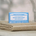 Dr. Bronner's Magic Bar Soap on a textured surface with a blurred background