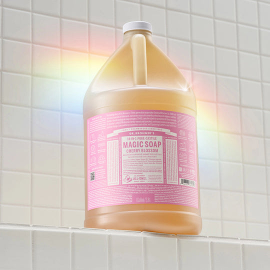 Gallon container of Dr. Bronner's Magic Soap on a tiled bathroom wall. [1 Gallon]