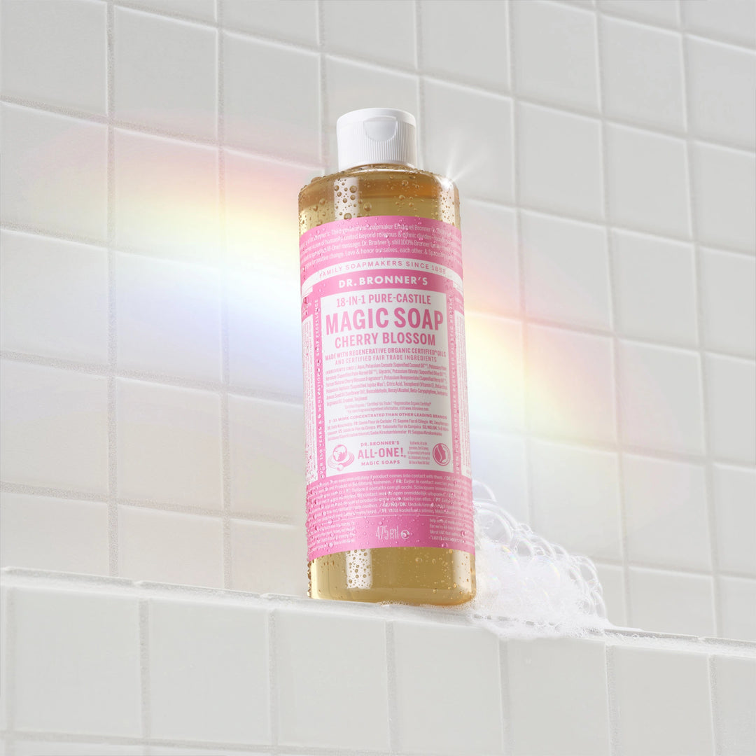 Bottle of Dr. Bronner's Magic Soap on a tiled bathroom wall  [16 oz]