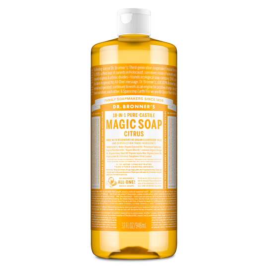 A large bottle of Dr. Bronners 18 in 1 Pure Castile Magic Soap, Citrus variant, stands upright. The label highlights family soapmakers, organic certification, and versatility for multiple cleaning uses. Capacity is 32 fl oz [32 oz]