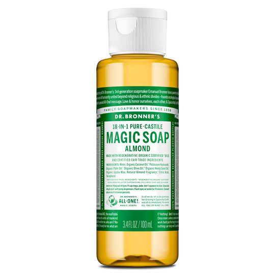 A small bottle labeled Dr. Bronners 18 in 1 Pure Castile Magic Soap Almond contains liquid castile soap in a clear container with a white flip top cap, featuring green, detailed text [3.4 oz]