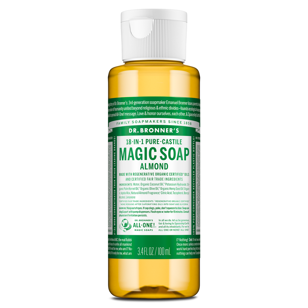 A small bottle labeled Dr. Bronners 18 in 1 Pure Castile Magic Soap Almond contains liquid castile soap in a clear container with a white flip top cap, featuring green, detailed text [3.4 oz]