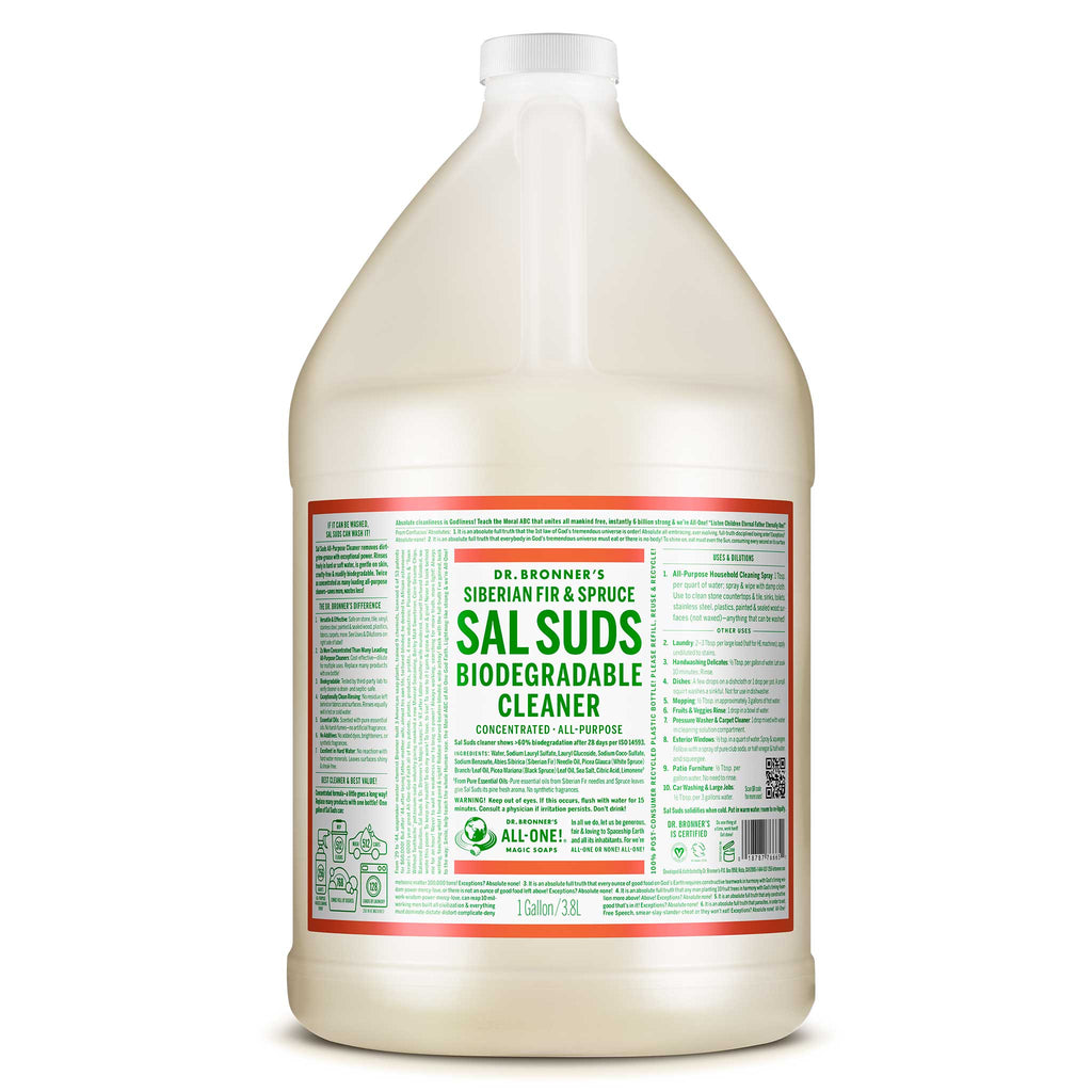 A large, clear bottle labeled Dr. Bronners Sal Suds Biodegradable Cleaner stands on a white background, promoting eco friendly cleaning with bold green and red text. Text includes usage instructions and ingredients [1 Gallon]